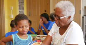 Grandmother and grandson reading a children's book together in a classroom at a Springboard Collaborative family workshop