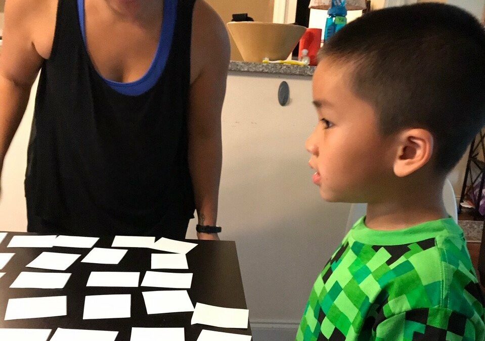 Mother and child practicing sight word flashcards together in a living room